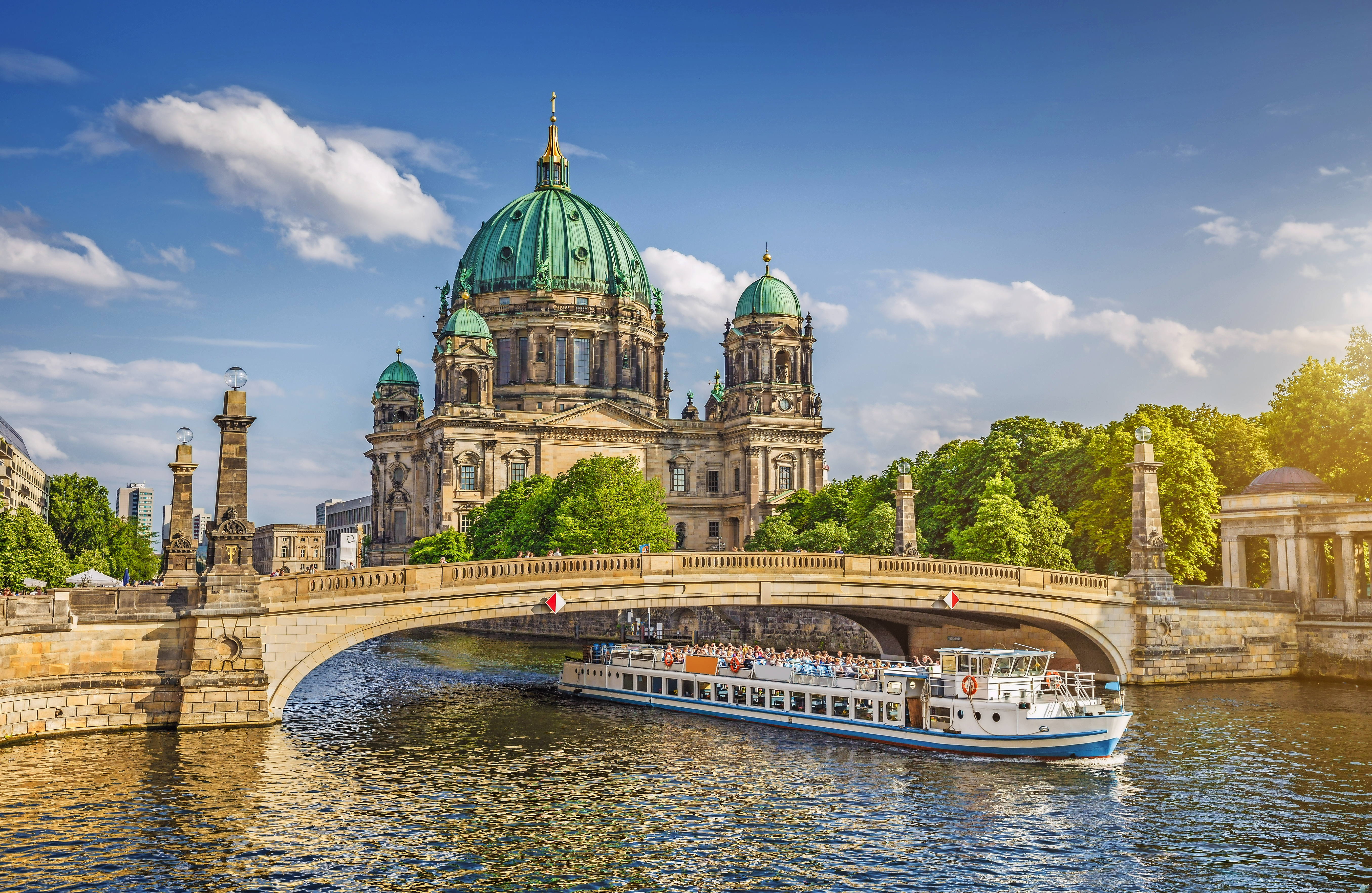Berlin Cathedral with ship on Spree river at sunset, Berlin Mitte, Germany